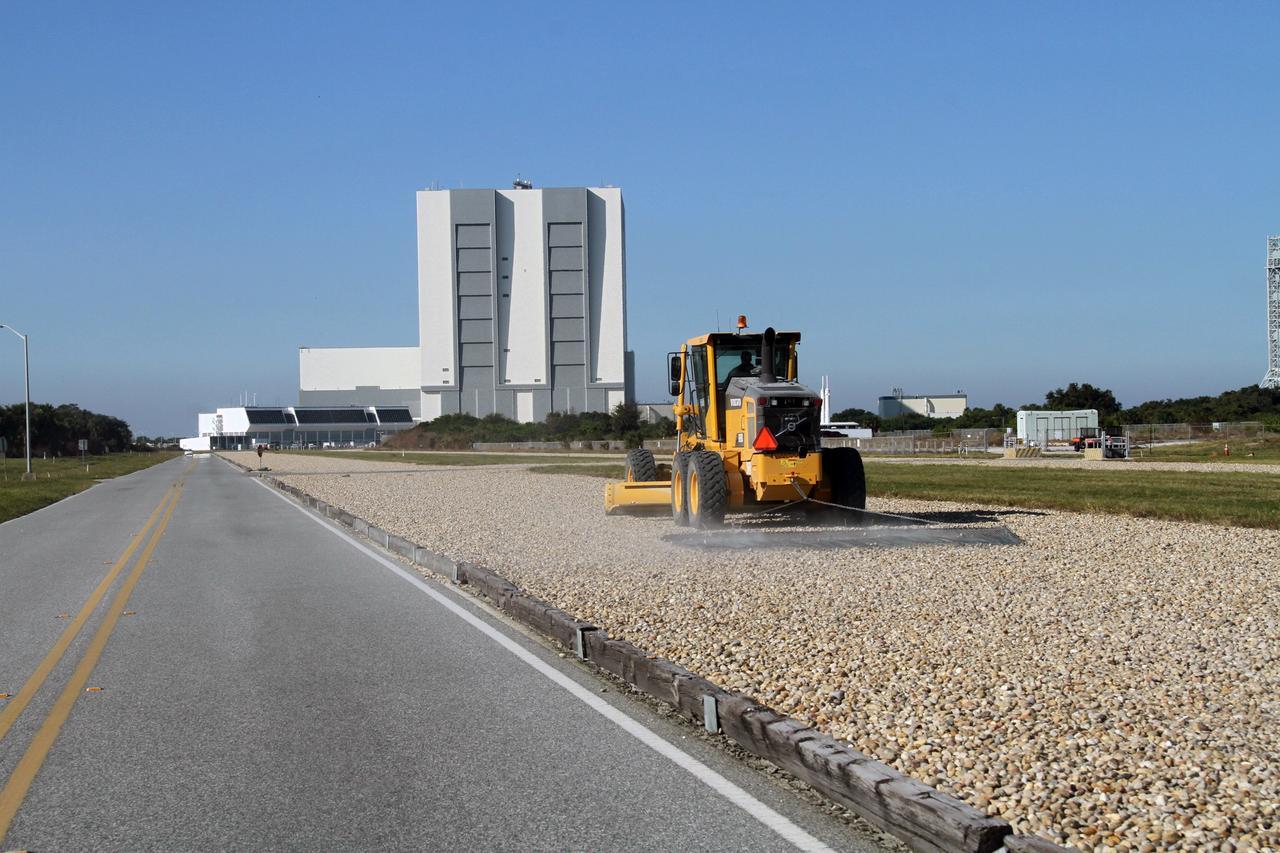 CAPE CANAVERAL, Fla. -- At NASA's Kennedy Space Center in Florida, a tractor levels out the gravel after the six-million-pound crawler-transporter passed by on its way from the Vehicle Assembly Building to Launch Pad 39A. The test drive is designed to check out recently completed modifications to ensure the crawler-transporter's ability to carry launch vehicles such as the space agency's Space Launch System heavy-lift rocket to the pad. NASA's Ground Systems Development and Operations Program is leading the 20-year life-extension project for the crawler. A pair of behemoth machines called crawler-transporters has carried the load of taking rockets and spacecraft to the launch pad for more than 40 years at NASA’s Kennedy Space Center in Florida. Each the size of a baseball infield and powered by locomotive and large electrical power generator engines, the crawler-transporters will stand ready to keep up the work for the next generation of launch vehicles projects to lift astronauts into space. For more information, visit http://www.nasa.gov/exploration/systems/ground/index.html Photo credit: NASA/Ben Smegelsky
