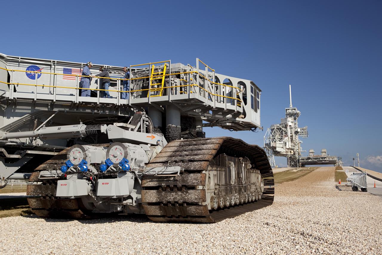CAPE CANAVERAL, Fla. -- At NASA's Kennedy Space Center in Florida, crawler-transporter No. 2 arrives at Launch Pad 39A to check out recently completed modifications to ensure its ability to carry launch vehicles such as the space agency's Space Launch System heavy-lift rocket to the pad. NASA's Ground Systems Development and Operations Program is leading the 20-year life-extension project for the crawler. A pair of behemoth machines called crawler-transporters has carried the load of taking rockets and spacecraft to the launch pad for more than 40 years at NASA’s Kennedy Space Center in Florida. Each the size of a baseball infield and powered by locomotive and large electrical power generator engines, the crawler-transporters will stand ready to keep up the work for the next generation of launch vehicles to lift astronauts into space. For more information, visit http://www.nasa.gov/exploration/systems/ground/index.html Photo credit: NASA/ Dimitri Gerondidakis