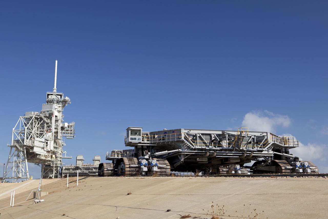 CAPE CANAVERAL, Fla. -- At NASA's Kennedy Space Center in Florida, crawler-transporter No. 2 arrives at Launch Pad 39A to check out recently completed modifications to ensure its ability to carry launch vehicles such as the space agency's Space Launch System heavy-lift rocket to the pad. NASA's Ground Systems Development and Operations Program is leading the 20-year life-extension project for the crawler. A pair of behemoth machines called crawler-transporters has carried the load of taking rockets and spacecraft to the launch pad for more than 40 years at NASA’s Kennedy Space Center in Florida. Each the size of a baseball infield and powered by locomotive and large electrical power generator engines, the crawler-transporters will stand ready to keep up the work for the next generation of launch vehicles to lift astronauts into space. For more information, visit http://www.nasa.gov/exploration/systems/ground/index.html Photo credit: NASA/ Dimitri Gerondidakis