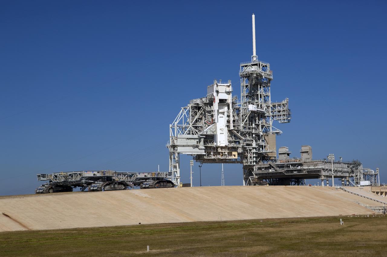 CAPE CANAVERAL, Fla. -- At NASA's Kennedy Space Center in Florida, crawler-transporter No. 2 arrives at Launch Pad 39A to check out recently completed modifications to ensure its ability to carry launch vehicles such as the space agency's Space Launch System heavy-lift rocket to the pad. NASA's Ground Systems Development and Operations Program is leading the 20-year life-extension project for the crawler. A pair of behemoth machines called crawler-transporters has carried the load of taking rockets and spacecraft to the launch pad for more than 40 years at NASA’s Kennedy Space Center in Florida. Each the size of a baseball infield and powered by locomotive and large electrical power generator engines, the crawler-transporters will stand ready to keep up the work for the next generation of launch vehicles to lift astronauts into space. For more information, visit http://www.nasa.gov/exploration/systems/ground/index.html Photo credit: NASA/ Dimitri Gerondidakis