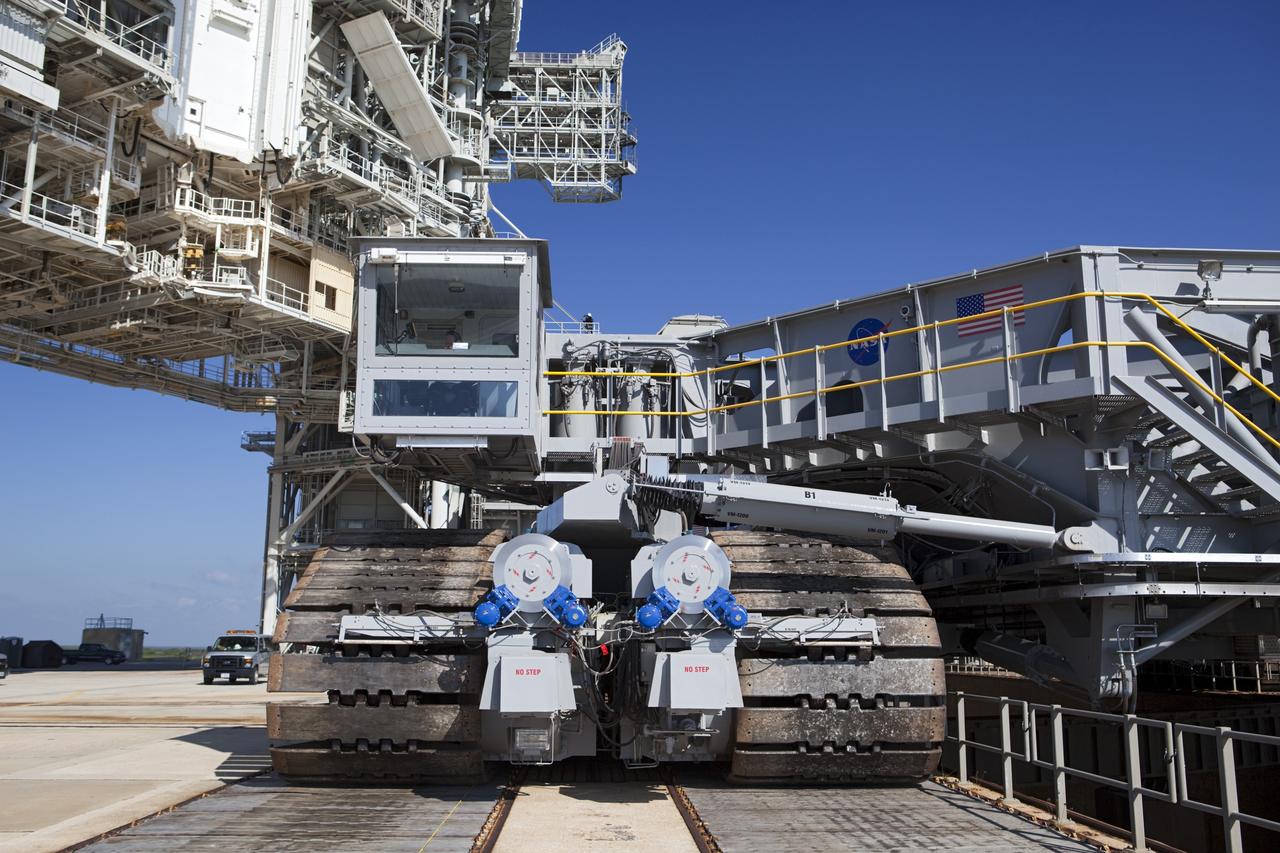 CAPE CANAVERAL, Fla. -- At NASA's Kennedy Space Center in Florida, crawler-transporter No. 2 arrives at Launch Pad 39A to check out recently completed modifications to ensure its ability to carry launch vehicles such as the space agency's Space Launch System heavy-lift rocket to the pad. NASA's Ground Systems Development and Operations Program is leading the 20-year life-extension project for the crawler. A pair of behemoth machines called crawler-transporters has carried the load of taking rockets and spacecraft to the launch pad for more than 40 years at NASA’s Kennedy Space Center in Florida. Each the size of a baseball infield and powered by locomotive and large electrical power generator engines, the crawler-transporters will stand ready to keep up the work for the next generation of launch vehicles to lift astronauts into space. For more information, visit http://www.nasa.gov/exploration/systems/ground/index.html Photo credit: NASA/ Dimitri Gerondidakis