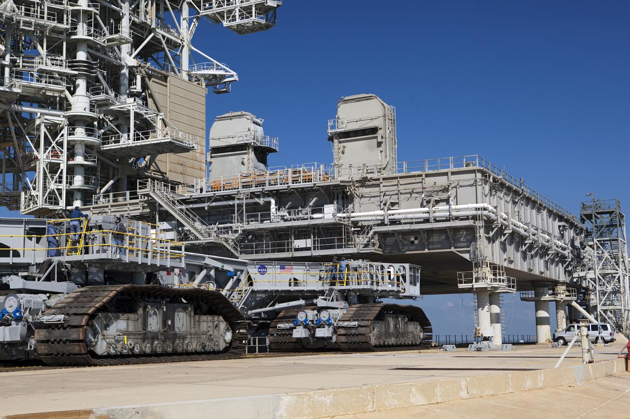 CAPE CANAVERAL, Fla. -- At NASA's Kennedy Space Center in Florida, crawler-transporter No. 2 arrives at Launch Pad 39A to check out recently completed modifications to ensure its ability to carry launch vehicles such as the space agency's Space Launch System heavy-lift rocket to the pad. NASA's Ground Systems Development and Operations Program is leading the 20-year life-extension project for the crawler. A pair of behemoth machines called crawler-transporters has carried the load of taking rockets and spacecraft to the launch pad for more than 40 years at NASA’s Kennedy Space Center in Florida. Each the size of a baseball infield and powered by locomotive and large electrical power generator engines, the crawler-transporters will stand ready to keep up the work for the next generation of launch vehicles to lift astronauts into space. For more information, visit http://www.nasa.gov/exploration/systems/ground/index.html Photo credit: NASA/ Dimitri Gerondidakis