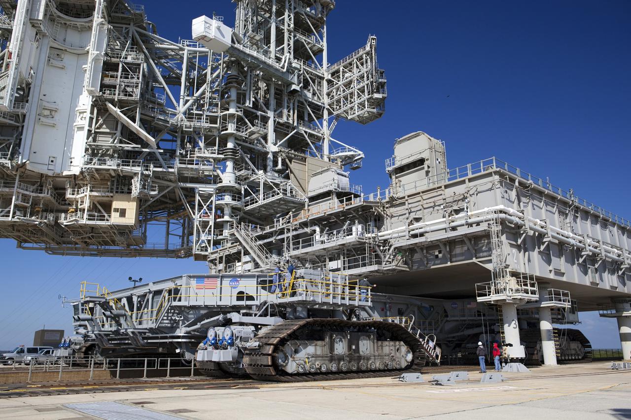 CAPE CANAVERAL, Fla. -- At NASA's Kennedy Space Center in Florida, crawler-transporter No. 2 arrives at Launch Pad 39A to check out recently completed modifications to ensure its ability to carry launch vehicles such as the space agency's Space Launch System heavy-lift rocket to the pad. NASA's Ground Systems Development and Operations Program is leading the 20-year life-extension project for the crawler. A pair of behemoth machines called crawler-transporters has carried the load of taking rockets and spacecraft to the launch pad for more than 40 years at NASA’s Kennedy Space Center in Florida. Each the size of a baseball infield and powered by locomotive and large electrical power generator engines, the crawler-transporters will stand ready to keep up the work for the next generation of launch vehicles to lift astronauts into space. For more information, visit http://www.nasa.gov/exploration/systems/ground/index.html Photo credit: NASA/ Dimitri Gerondidakis