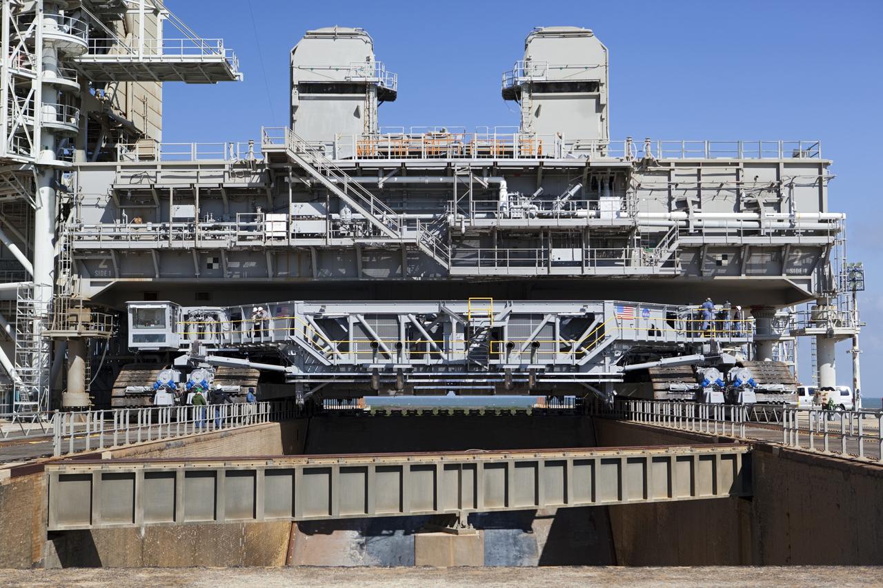 CAPE CANAVERAL, Fla. -- At NASA's Kennedy Space Center in Florida, crawler-transporter No. 2 arrives at Launch Pad 39A to check out recently completed modifications to ensure its ability to carry launch vehicles such as the space agency's Space Launch System heavy-lift rocket to the pad. NASA's Ground Systems Development and Operations Program is leading the 20-year life-extension project for the crawler. A pair of behemoth machines called crawler-transporters has carried the load of taking rockets and spacecraft to the launch pad for more than 40 years at NASA’s Kennedy Space Center in Florida. Each the size of a baseball infield and powered by locomotive and large electrical power generator engines, the crawler-transporters will stand ready to keep up the work for the next generation of launch vehicles to lift astronauts into space. For more information, visit http://www.nasa.gov/exploration/systems/ground/index.html Photo credit: NASA/ Dimitri Gerondidakis