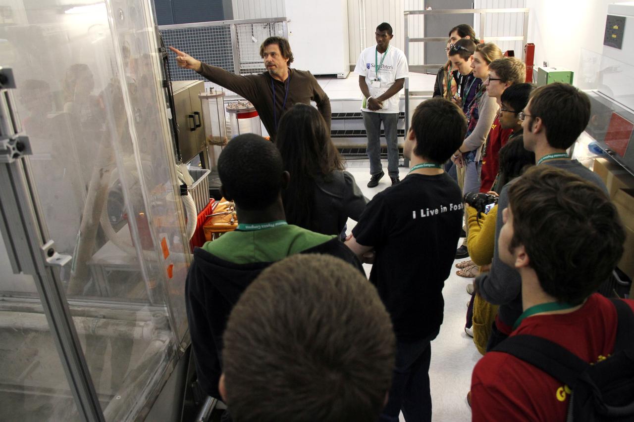 CAPE CANAVERAL, Fla. -- Inside a laboratory in the Engineering Development Laboratory, or EDL, at NASA’s Kennedy Space Center in Florida, research physicist Phil Metzger describes lunar excavators and soil processing technologies to a group of Society of Physics students.    About 800 graduate and undergraduate physics students toured Kennedy facilities. A group of about 40 students toured laboratories in the Operations and Checkout Building and the EDL during their visit. The physics students were in Orlando for the 2012 Quadrennial Physics Congress. Photo credit: NASA/Cory Huston