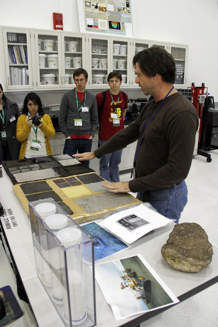CAPE CANAVERAL, Fla. -- Inside a laboratory in the Engineering Development Laboratory, or EDL, at NASA’s Kennedy Space Center in Florida, research physicist Phil Metzger describes lunar excavators and soil processing technologies to a group of Society of Physics students.    About 800 graduate and undergraduate physics students toured Kennedy facilities. A group of about 40 students toured laboratories in the Operations and Checkout Building and the EDL during their visit. The physics students were in Orlando for the 2012 Quadrennial Physics Congress. Photo credit: NASA/Cory Huston