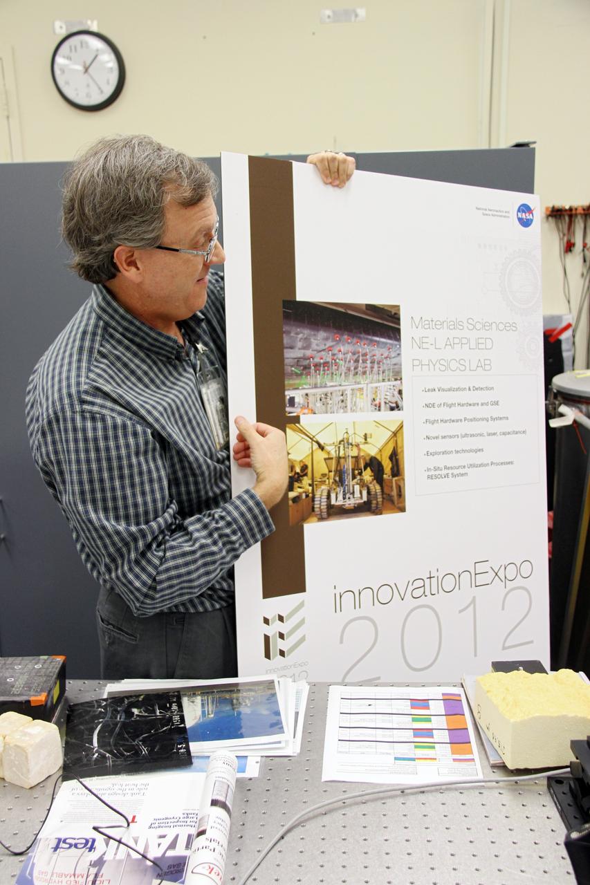 CAPE CANAVERAL, Fla. -- Inside the Applied Physics Laboratory in the Operations and Checkout Building at NASA’s Kennedy Space Center in Florida, lead researcher Dr. Bob Youngquist describes technologies developed for the Space Shuttle Program to a group of Society of Physics students. About 800 graduate and undergraduate physics students toured Kennedy facilities. A group of about 40 students toured laboratories in the Operations and Checkout Building and the EDL during their visit. The physics students were in Orlando for the 2012 Quadrennial Physics Congress. Photo credit: NASA/Cory Huston