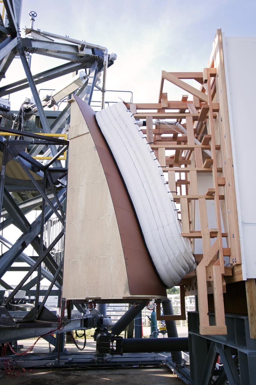 CAPE CANAVERAL, Fla. – The Orion spacecraft crew access arm, or CAA, seal prototype is being checked out at the Launch Equipment Test Facility at NASA's Kennedy Space Center in Florida. The tests will use a mockup of the vehicle Outer Mold Line and CAA white room to test the performance of the seal while simulating vehicle to CAA white room excursions. Orion is the exploration spacecraft designed to carry crews to space beyond low Earth orbit. It will provide emergency abort capability, sustain the crew during the space travel and provide safe re-entry from deep space return velocities. The first unpiloted test flight of the Orion is scheduled to launch in 2014 atop a Delta IV rocket and in 2017 on a Space Launch System rocket. For more information, visit http://www.nasa.gov/orion Photo credit: NASA/Jim Grossmann
