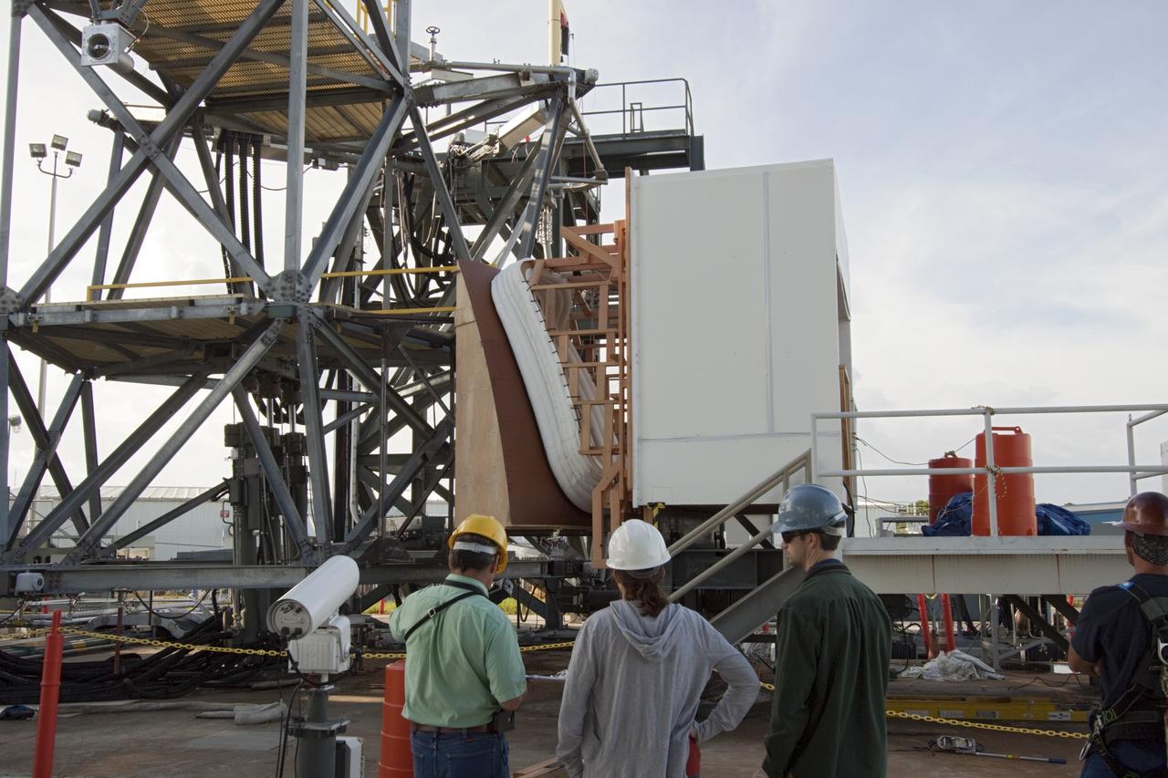 CAPE CANAVERAL, Fla. – The Orion spacecraft crew access arm, or CAA, seal prototype is being checked out at the Launch Equipment Test Facility at NASA's Kennedy Space Center in Florida. Monitoring the activity, from the left are Kent Bachelor, Stinger Ghaffarian Technologies lead, Kelli Maloney, NASA lead and Clayton Gvasse, Nelson Engineering lead. The tests will use a mockup of the vehicle Outer Mold Line and CAA white room to test the performance of the seal while simulating vehicle to CAA white room excursions. Orion is the exploration spacecraft designed to carry crews to space beyond low Earth orbit. It will provide emergency abort capability, sustain the crew during the space travel and provide safe re-entry from deep space return velocities. The first unpiloted test flight of the Orion is scheduled to launch in 2014 atop a Delta IV rocket and in 2017 on a Space Launch System rocket. For more information, visit http://www.nasa.gov/orion Photo credit: NASA/Jim Grossmann