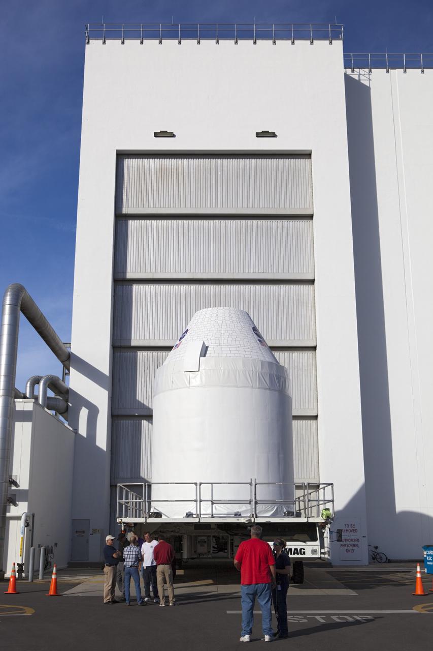CAPE CANAVERAL, Fla. – A full-size test mock-up of the Orion spacecraft moves from the Operations and Checkout Building at NASA's Kennedy Space Center in Florida. The test article is on its way to the Multi-Payload Processing Facility, or MPPF, to test the path flight hardware will take during future launch processing. Orion is the exploration spacecraft designed to carry crews to space beyond low Earth orbit. It will provide emergency abort capability, sustain the crew during the space travel and provide safe re-entry from deep space return velocities. The first unpiloted test flight of the Orion is scheduled to launch in 2014 atop a Delta IV rocket and in 2017 on a Space Launch System rocket. For more information, visit http://www.nasa.gov/orion Photo credit: NASA/Dimitri Gerondidakis