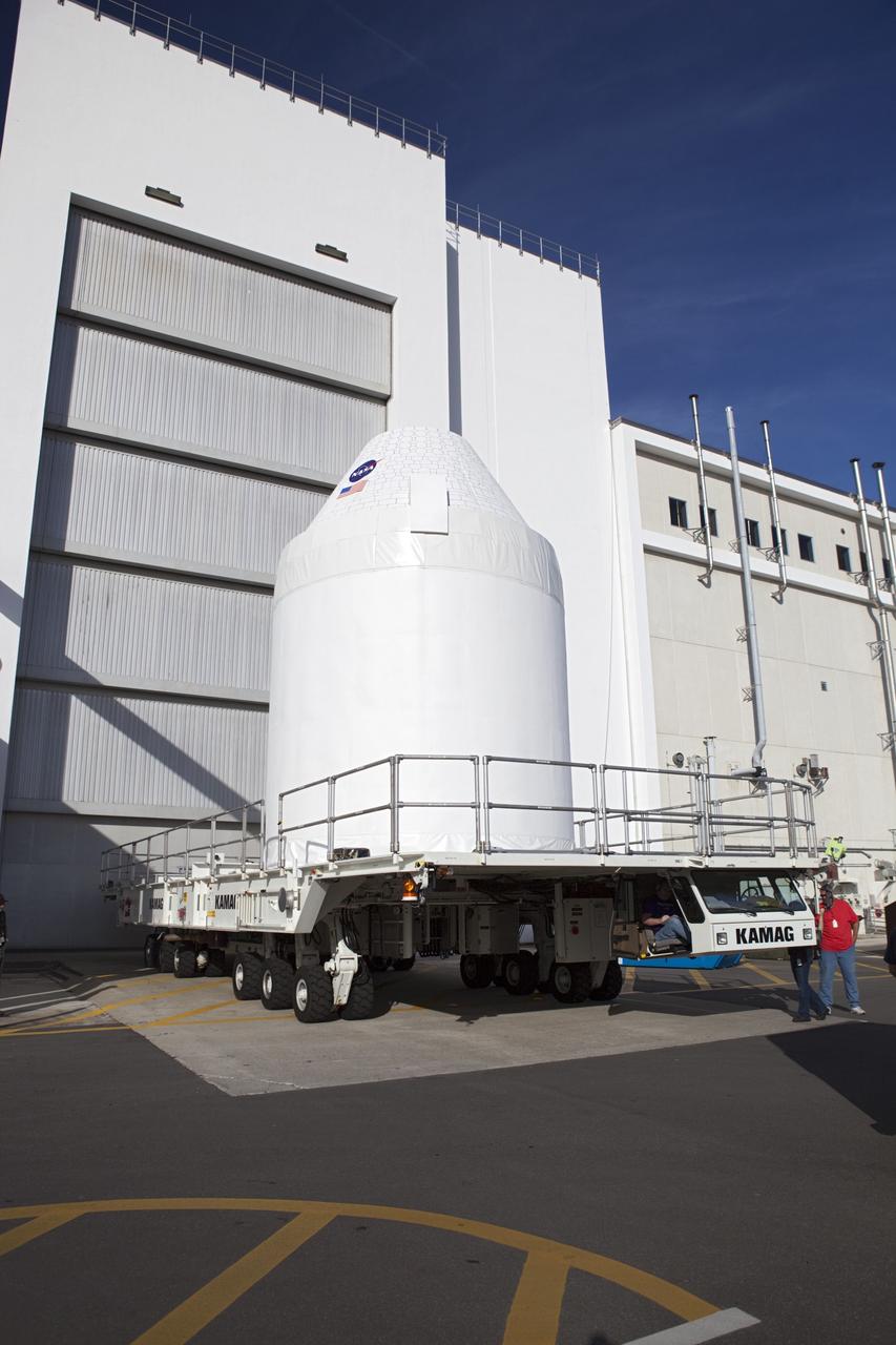 CAPE CANAVERAL, Fla. – A full-size test mock-up of the Orion crew exploration vehicle from of the Operations and Checkout Building at NASA's Kennedy Space Center in Florida. The test article is on its way to the Multi-Payload Processing Facility, or MPPF, to test the path flight hardware will take during future launch processing. Orion is the exploration spacecraft designed to carry crews to space beyond low Earth orbit. It will provide emergency abort capability, sustain the crew during the space travel and provide safe re-entry from deep space return velocities. The first unpiloted test flight of the Orion is scheduled to launch in 2014 atop a Delta IV rocket and in 2017 on a Space Launch System rocket. For more information, visit http://www.nasa.gov/orion Photo credit: NASA/Dimitri Gerondidakis