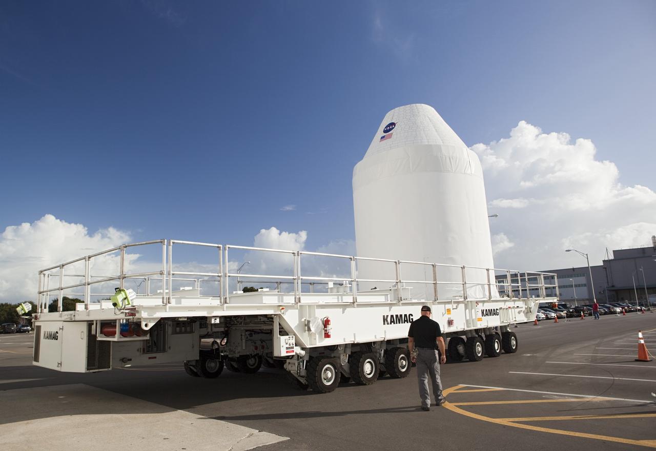 CAPE CANAVERAL, Fla. – A full-size test mock-up of the Orion spacecraft from of the Operations and Checkout Building at NASA's Kennedy Space Center in Florida. The test article is on its way to the Multi-Payload Processing Facility, or MPPF, to test the path flight hardware will take during future launch processing. Orion is the exploration spacecraft designed to carry crews to space beyond low Earth orbit. It will provide emergency abort capability, sustain the crew during the space travel and provide safe re-entry from deep space return velocities. The first unpiloted test flight of the Orion is scheduled to launch in 2014 atop a Delta IV rocket and in 2017 on a Space Launch System rocket. For more information, visit http://www.nasa.gov/orion Photo credit: NASA/Dimitri Gerondidakis