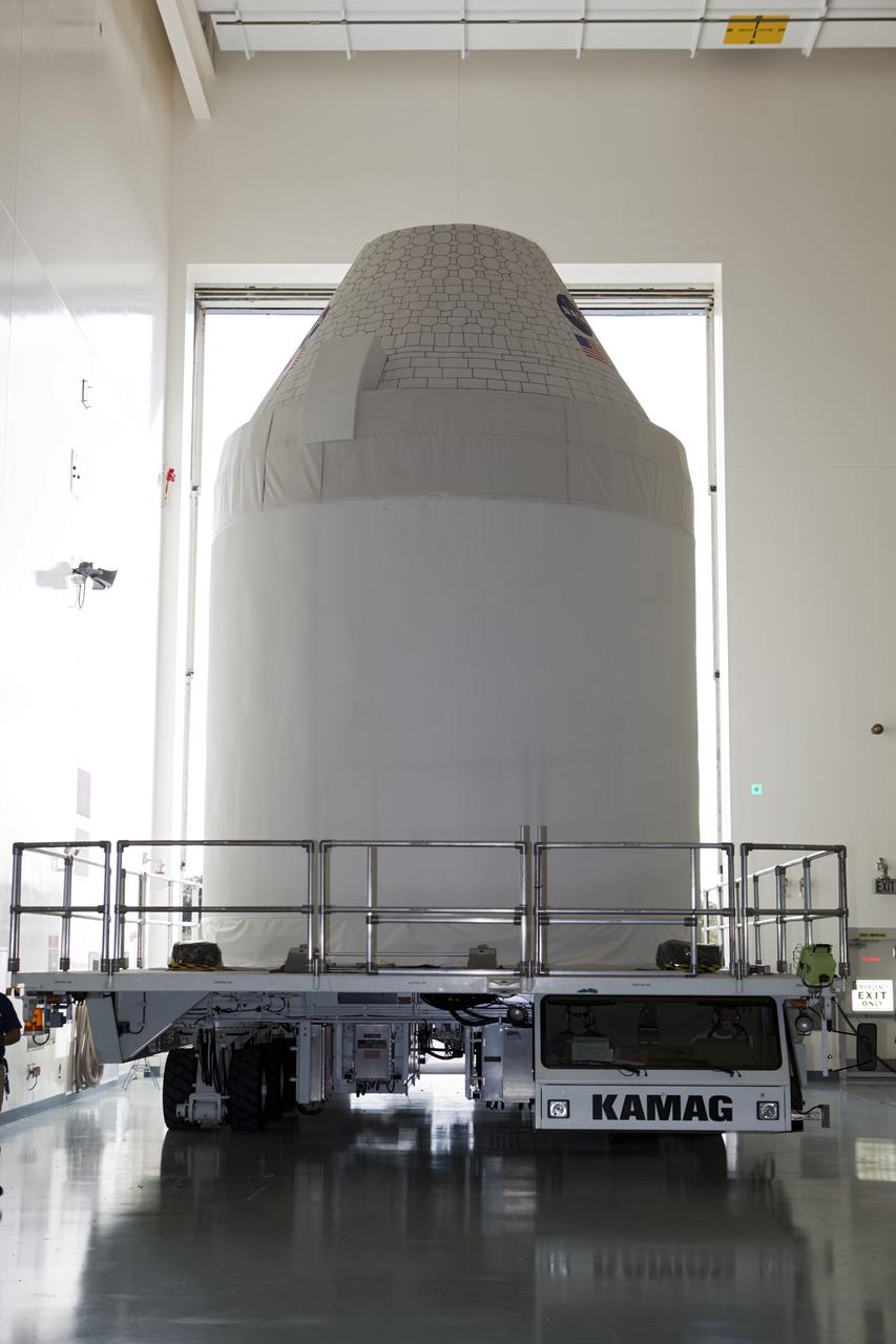 CAPE CANAVERAL, Fla. – A full-size test mock-up of the Orion spacecraft moves inside the Multi-Payload Processing Facility, or MPPF, at NASA's Kennedy Space Center in Florida to test the path flight hardware will take during future launch processing. Orion is the exploration spacecraft designed to carry crews to space beyond low Earth orbit. It will provide emergency abort capability, sustain the crew during the space travel and provide safe re-entry from deep space return velocities. The first unpiloted test flight of the Orion is scheduled to launch in 2014 atop a Delta IV rocket and in 2017 on a Space Launch System rocket. For more information, visit http://www.nasa.gov/orion Photo credit: NASA/Dimitri Gerondidakis