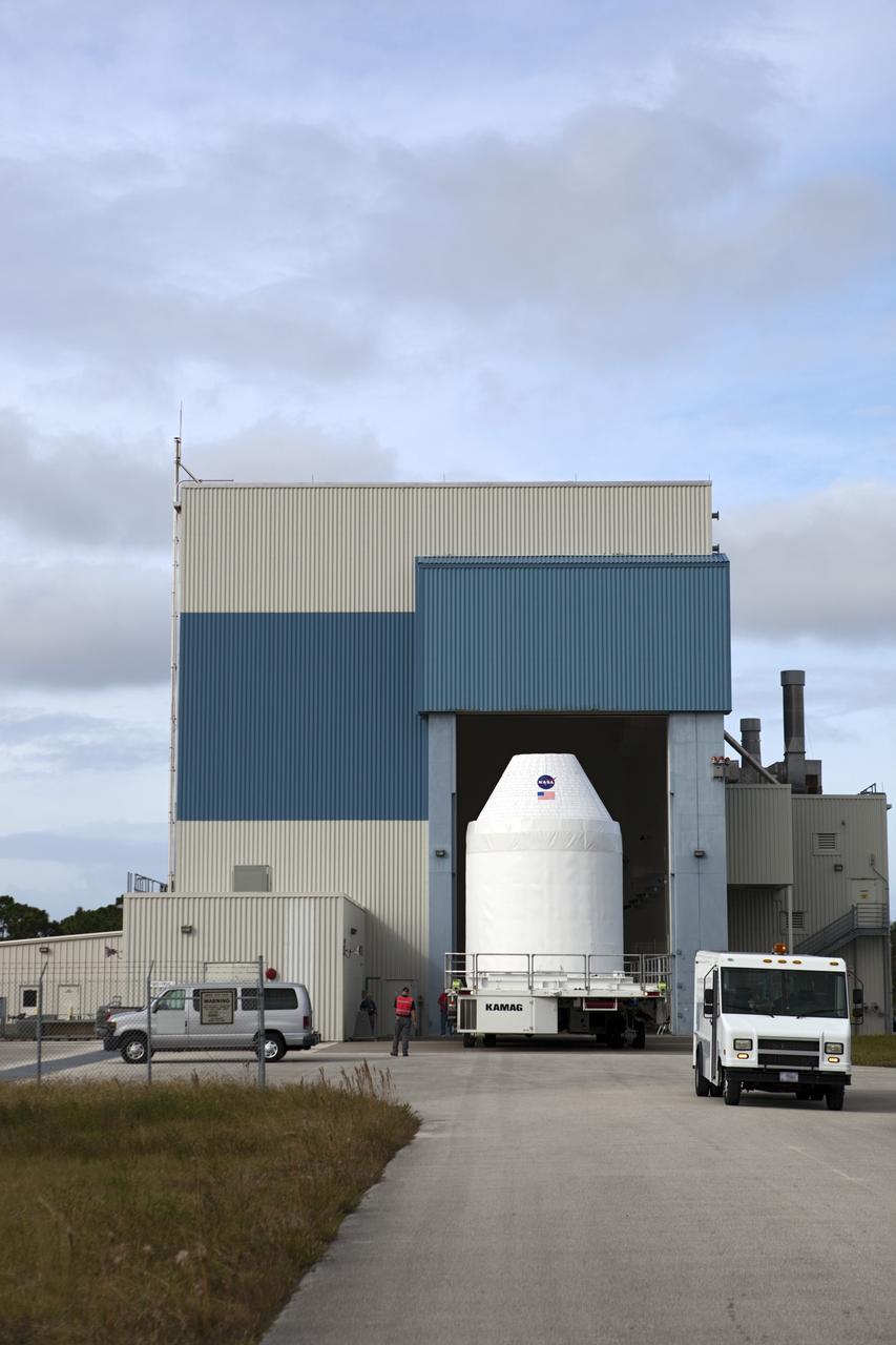 CAPE CANAVERAL, Fla. – A full-size test mock-up of the Orion spacecraft moves out of the Multi-Payload Processing Facility, or MPPF, at NASA's Kennedy Space Center in Florida to test the path flight hardware will take during future launch processing. Orion is the exploration spacecraft designed to carry crews to space beyond low Earth orbit. It will provide emergency abort capability, sustain the crew during the space travel and provide safe re-entry from deep space return velocities. The first unpiloted test flight of the Orion is scheduled to launch in 2014 atop a Delta IV rocket and in 2017 on a Space Launch System rocket. For more information, visit http://www.nasa.gov/orion Photo credit: NASA/Dimitri Gerondidakis