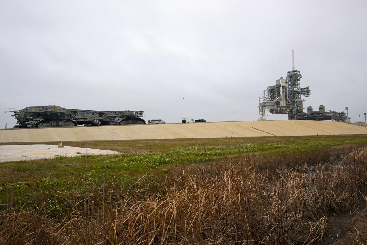 CAPE CANAVERAL, Fla. -- At NASA's Kennedy Space Center in Florida, crawler-transporter No. 2 moves up the gravel crawler way at Launch Pad 39A. The crawler-transporter is undergoing testing to check out recently completed modifications to ensure its ability to carry launch vehicles such as the space agency's Space Launch System heavy-lift rocket to the pad. NASA's Ground Systems Development and Operations Program is leading the 20-year life-extension project for the crawler. A pair of behemoth machines called crawler-transporters has carried the load of taking rockets and spacecraft to the launch pad for more than 40 years at NASA’s Kennedy Space Center in Florida. Each weighing six and a half million pounds and larger in size than a professional baseball infield, the crawler-transporters are powered by locomotive and large electrical power generator engines. The crawler-transporters will stand ready to keep up the work for the next generation of launch vehicles to lift astronauts into space. For more information, visit http://www.nasa.gov/exploration/systems/ground/index.html Photo credit: NASA/ Jim Grossmann