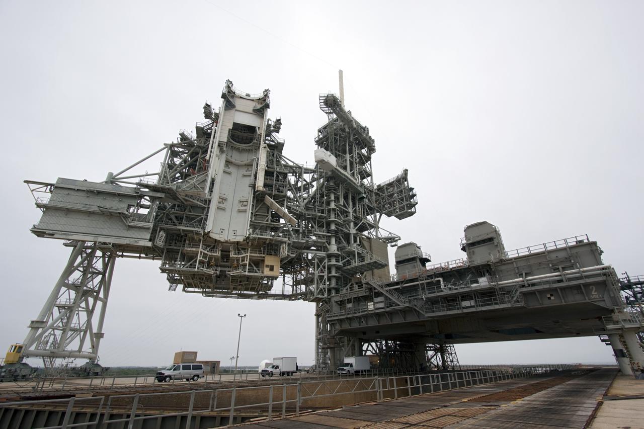CAPE CANAVERAL, Fla. -- A space shuttle era mobile launcher platform remains on Launch Pad 39A at NASA's Kennedy Space Center in Florida. It will be moved by crawler-transporter No. 2 as part of testing to check out recently completed modifications to ensure its ability to carry launch vehicles such as the space agency's Space Launch System heavy-lift rocket to the pad. NASA's Ground Systems Development and Operations Program is leading the 20-year life-extension project for the crawler. A pair of behemoth machines called crawler-transporters has carried the load of taking rockets and spacecraft to the launch pad for more than 40 years at NASA’s Kennedy Space Center in Florida. Each weighing six and a half million pounds and larger in size than a professional baseball infield, the crawler-transporters are powered by locomotive and large electrical power generator engines. The crawler-transporters will stand ready to keep up the work for the next generation of launch vehicles to lift astronauts into space. For more information, visit http://www.nasa.gov/exploration/systems/ground/index.html Photo credit: NASA/ Jim Grossmann
