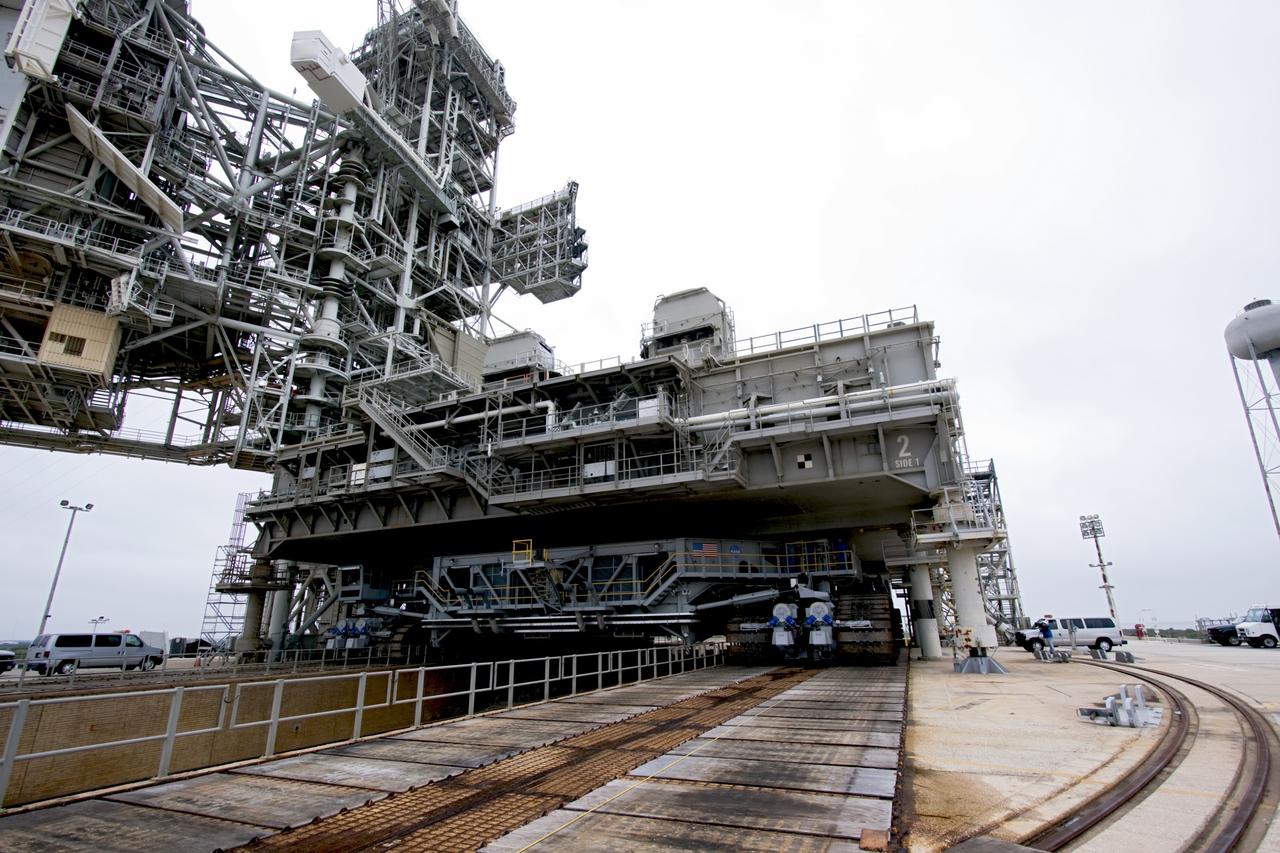 CAPE CANAVERAL, Fla. -- At NASA's Kennedy Space Center in Florida, crawler-transporter No. 2 moves under a space shuttle era mobile launcher platform on Launch Pad 39A. The activity was part of testing to check out recently completed modifications to ensure its ability to carry launch vehicles such as the space agency's Space Launch System heavy-lift rocket to the pad. NASA's Ground Systems Development and Operations Program is leading the 20-year life-extension project for the crawler. A pair of behemoth machines called crawler-transporters has carried the load of taking rockets and spacecraft to the launch pad for more than 40 years at NASA’s Kennedy Space Center in Florida. Each weighing six and a half million pounds and larger in size than a professional baseball infield, the crawler-transporters are powered by locomotive and large electrical power generator engines. The crawler-transporters will stand ready to keep up the work for the next generation of launch vehicles to lift astronauts into space. For more information, visit http://www.nasa.gov/exploration/systems/ground/index.html Photo credit: NASA/ Jim Grossmann