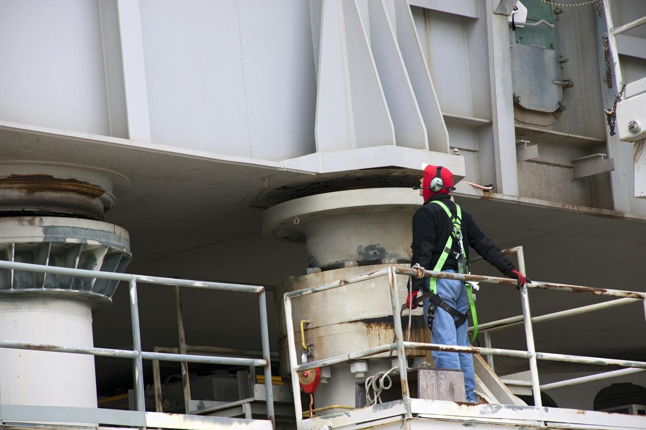 CAPE CANAVERAL, Fla. -- Technicians monitor progress as crawler-transporter No. 2 lifts a space shuttle era mobile launcher platform at Launch Pad 39A at NASA's Kennedy Space Center in Florida. The crawler-transporter is undergoing testing to check out recently completed modifications to ensure its ability to carry launch vehicles such as the space agency's Space Launch System heavy-lift rocket to the pad. NASA's Ground Systems Development and Operations Program is leading the 20-year life-extension project for the crawler. A pair of behemoth machines called crawler-transporters has carried the load of taking rockets and spacecraft to the launch pad for more than 40 years at NASA’s Kennedy Space Center in Florida. Each weighing six and a half million pounds and larger in size than a professional baseball infield, the crawler-transporters are powered by locomotive and large electrical power generator engines. The crawler-transporters will stand ready to keep up the work for the next generation of launch vehicles to lift astronauts into space. For more information, visit http://www.nasa.gov/exploration/systems/ground/index.html Photo credit: NASA/ Jim Grossmann