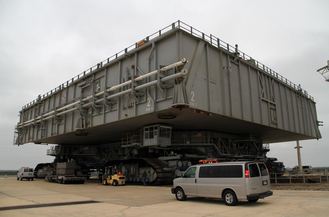 CAPE CANAVERAL, Fla. -- At NASA's Kennedy Space Center in Florida, crawler-transporter No. 2 moves a space shuttle era mobile launcher platform at Launch Pad 39A. The activity was part of testing to check out recently completed modifications to ensure its ability to carry launch vehicles such as the space agency's Space Launch System heavy-lift rocket to the pad. NASA's Ground Systems Development and Operations Program is leading the 20-year life-extension project for the crawler. A pair of behemoth machines called crawler-transporters has carried the load of taking rockets and spacecraft to the launch pad for more than 40 years at NASA’s Kennedy Space Center in Florida. Each weighing six and a half million pounds and larger in size than a professional baseball infield, the crawler-transporters are powered by locomotive and large electrical power generator engines. The crawler-transporters will stand ready to keep up the work for the next generation of launch vehicles to lift astronauts into space. For more information, visit http://www.nasa.gov/exploration/systems/ground/index.html Photo credit: NASA/Cory Huston