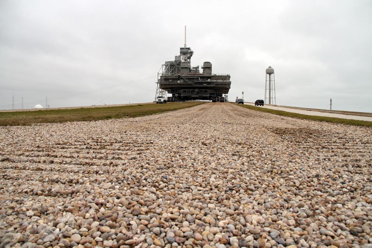 CAPE CANAVERAL, Fla. -- At NASA's Kennedy Space Center in Florida, crawler-transporter No. 2 moves a space shuttle era mobile launcher platform down the gravel crawler way at Launch Pad 39A. The activity was part of testing to check out recently completed modifications to ensure its ability to carry launch vehicles such as the space agency's Space Launch System heavy-lift rocket to the pad. NASA's Ground Systems Development and Operations Program is leading the 20-year life-extension project for the crawler. A pair of behemoth machines called crawler-transporters has carried the load of taking rockets and spacecraft to the launch pad for more than 40 years at NASA’s Kennedy Space Center in Florida. Each weighing six and a half million pounds and larger in size than a professional baseball infield, the crawler-transporters are powered by locomotive and large electrical power generator engines. The crawler-transporters will stand ready to keep up the work for the next generation of launch vehicles to lift astronauts into space. For more information, visit http://www.nasa.gov/exploration/systems/ground/index.html Photo credit: NASA/Cory Huston
