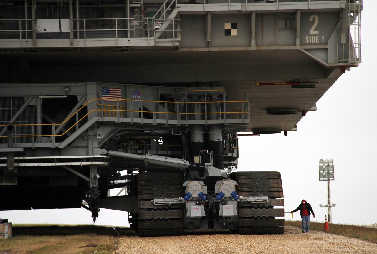 CAPE CANAVERAL, Fla. -- A technician monitors operations as crawler-transporter No. 2 moves a space shuttle era mobile launcher platform down the gravel crawler way at Launch Pad 39A at NASA's Kennedy Space Center in Florida. The activity was part of testing to check out recently completed modifications to ensure its ability to carry launch vehicles such as the space agency's Space Launch System heavy-lift rocket to the pad. NASA's Ground Systems Development and Operations Program is leading the 20-year life-extension project for the crawler. A pair of behemoth machines called crawler-transporters has carried the load of taking rockets and spacecraft to the launch pad for more than 40 years at NASA’s Kennedy Space Center in Florida. Each weighing six and a half million pounds and larger in size than a professional baseball infield, the crawler-transporters are powered by locomotive and large electrical power generator engines. The crawler-transporters will stand ready to keep up the work for the next generation of launch vehicles to lift astronauts into space. For more information, visit http://www.nasa.gov/exploration/systems/ground/index.html Photo credit: NASA/Cory Huston