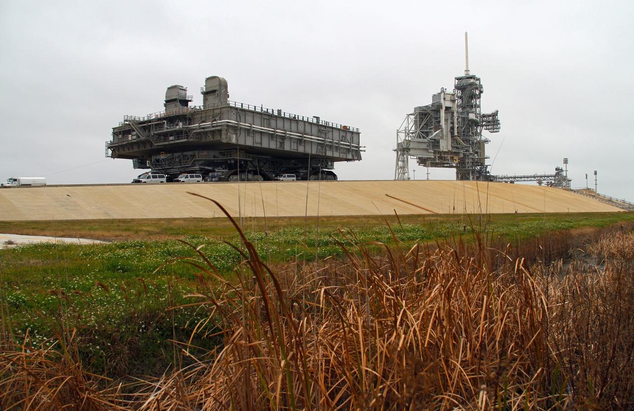 CAPE CANAVERAL, Fla. -- At NASA's Kennedy Space Center in Florida, crawler-transporter No. 2 moves a space shuttle era mobile launcher platform at Launch Pad 39A. The activity was part of testing to check out recently completed modifications to ensure its ability to carry launch vehicles such as the space agency's Space Launch System heavy-lift rocket to the pad. NASA's Ground Systems Development and Operations Program is leading the 20-year life-extension project for the crawler. A pair of behemoth machines called crawler-transporters has carried the load of taking rockets and spacecraft to the launch pad for more than 40 years at NASA’s Kennedy Space Center in Florida. Each weighing six and a half million pounds and larger in size than a professional baseball infield, the crawler-transporters are powered by locomotive and large electrical power generator engines. The crawler-transporters will stand ready to keep up the work for the next generation of launch vehicles to lift astronauts into space. For more information, visit http://www.nasa.gov/exploration/systems/ground/index.html Photo credit: NASA/Cory Huston