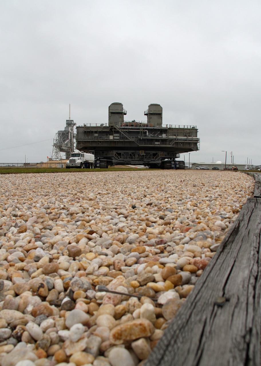 CAPE CANAVERAL, Fla. -- At NASA's Kennedy Space Center in Florida, crawler-transporter No. 2 moves a space shuttle era mobile launcher platform down the gravel crawler way at Launch Pad 39A. The activity was part of testing to check out recently completed modifications to ensure its ability to carry launch vehicles such as the space agency's Space Launch System heavy-lift rocket to the pad. NASA's Ground Systems Development and Operations Program is leading the 20-year life-extension project for the crawler. A pair of behemoth machines called crawler-transporters has carried the load of taking rockets and spacecraft to the launch pad for more than 40 years at NASA’s Kennedy Space Center in Florida. Each weighing six and a half million pounds and larger in size than a professional baseball infield, the crawler-transporters are powered by locomotive and large electrical power generator engines. The crawler-transporters will stand ready to keep up the work for the next generation of launch vehicles to lift astronauts into space. For more information, visit http://www.nasa.gov/exploration/systems/ground/index.html Photo credit: NASA/Cory Huston