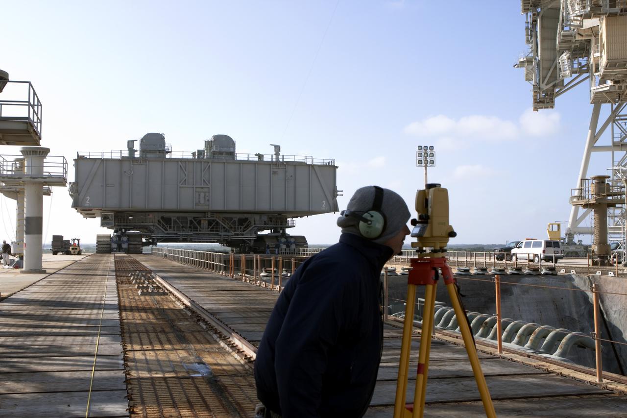 CAPE CANAVERAL, Fla. -- At NASA's Kennedy Space Center in Florida, a technician uses instrumentation to ensure accuracy as crawler-transporter No. 2 moves a space shuttle era mobile launcher platform into position for placement at Launch Pad 39A. The activity was part of testing to check out recently completed modifications to ensure its ability to carry launch vehicles such as the space agency's Space Launch System heavy-lift rocket to the pad. NASA's Ground Systems Development and Operations Program is leading the 20-year life-extension project for the crawler. A pair of behemoth machines called crawler-transporters has carried the load of taking rockets and spacecraft to the launch pad for more than 40 years at NASA’s Kennedy Space Center in Florida. Each weighing six and a half million pounds and larger in size than a professional baseball infield, the crawler-transporters are powered by locomotive and large electrical power generator engines. The crawler-transporters will stand ready to keep up the work for the next generation of launch vehicles to lift astronauts into space. For more information, visit http://www.nasa.gov/exploration/systems/ground/index.html Photo credit: NASA/Jim Grossmann