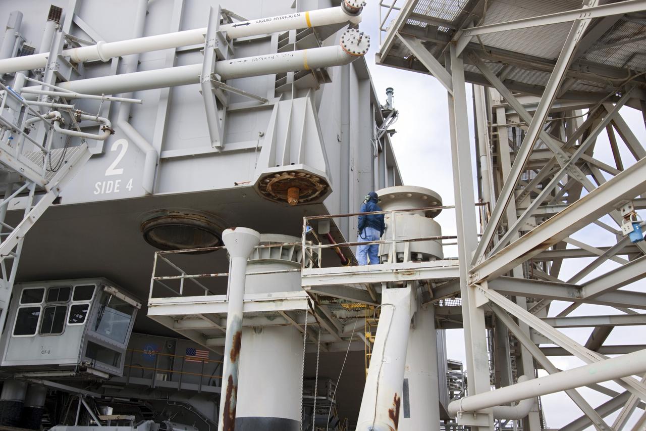 CAPE CANAVERAL, Fla. -- At NASA's Kennedy Space Center in Florida, a technician monitors operations as crawler-transporter No. 2 moves a space shuttle era mobile launcher platform over a support pedestal at Launch Pad 39A. The activity was part of testing to check out recently completed modifications to ensure its ability to carry launch vehicles such as the space agency's Space Launch System heavy-lift rocket to the pad. NASA's Ground Systems Development and Operations Program is leading the 20-year life-extension project for the crawler. A pair of behemoth machines called crawler-transporters has carried the load of taking rockets and spacecraft to the launch pad for more than 40 years at NASA’s Kennedy Space Center in Florida. Each weighing six and a half million pounds and larger in size than a professional baseball infield, the crawler-transporters are powered by locomotive and large electrical power generator engines. The crawler-transporters will stand ready to keep up the work for the next generation of launch vehicles to lift astronauts into space. For more information, visit http://www.nasa.gov/exploration/systems/ground/index.html Photo credit: NASA/Jim Grossmann