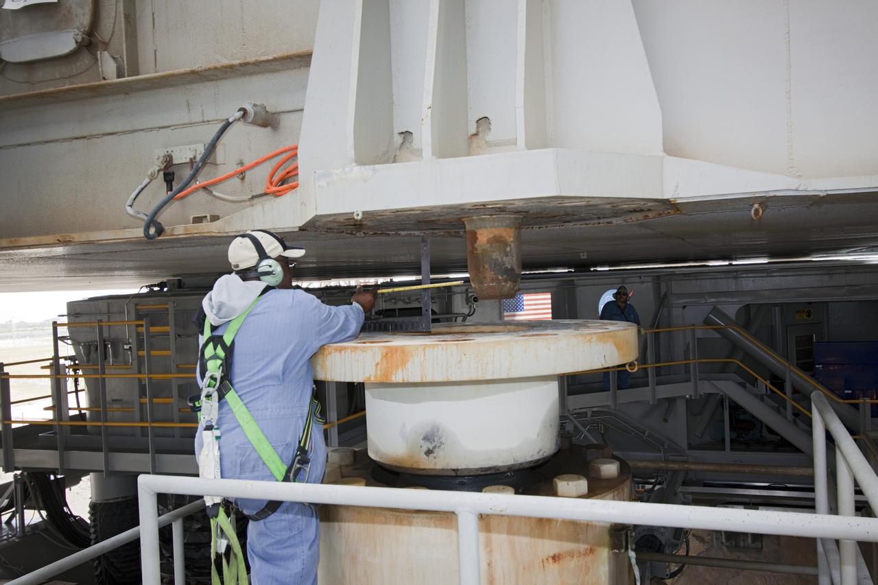 CAPE CANAVERAL, Fla. -- At NASA's Kennedy Space Center in Florida, a technician monitors operations as crawler-transporter No. 2 moves a space shuttle era mobile launcher platform over a support pedestal at Launch Pad 39A. The activity was part of testing to check out recently completed modifications to ensure its ability to carry launch vehicles such as the space agency's Space Launch System heavy-lift rocket to the pad. NASA's Ground Systems Development and Operations Program is leading the 20-year life-extension project for the crawler. A pair of behemoth machines called crawler-transporters has carried the load of taking rockets and spacecraft to the launch pad for more than 40 years at NASA’s Kennedy Space Center in Florida. Each weighing six and a half million pounds and larger in size than a professional baseball infield, the crawler-transporters are powered by locomotive and large electrical power generator engines. The crawler-transporters will stand ready to keep up the work for the next generation of launch vehicles to lift astronauts into space. For more information, visit http://www.nasa.gov/exploration/systems/ground/index.html Photo credit: NASA/Jim Grossmann