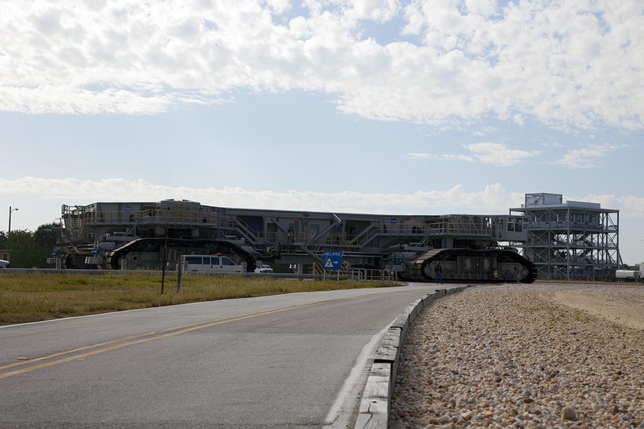 CAPE CANAVERAL, Fla. -- At NASA's Kennedy Space Center in Florida, crawler-transporter No. 2 moves along the gravel crawler way after completion of testing at Launch Pad 39A. The activity is designed to check out recently completed modifications to ensure the crawler-transporter's ability to carry launch vehicles such as the space agency's Space Launch System heavy-lift rocket to the pad. NASA's Ground Systems Development and Operations Program is leading the 20-year life-extension project for the crawler. A pair of behemoth machines called crawler-transporters has carried the load of taking rockets and spacecraft to the launch pad for more than 40 years at NASA’s Kennedy Space Center in Florida. Each weighing six and a half million pounds and larger in size than a professional baseball infield, the crawler-transporters are powered by locomotive and large electrical power generator engines. The crawler-transporters will stand ready to keep up the work for the next generation of launch vehicles to lift astronauts into space. For more information, visit http://www.nasa.gov/exploration/systems/ground/index.html Photo credit: NASA/Frankie Martin