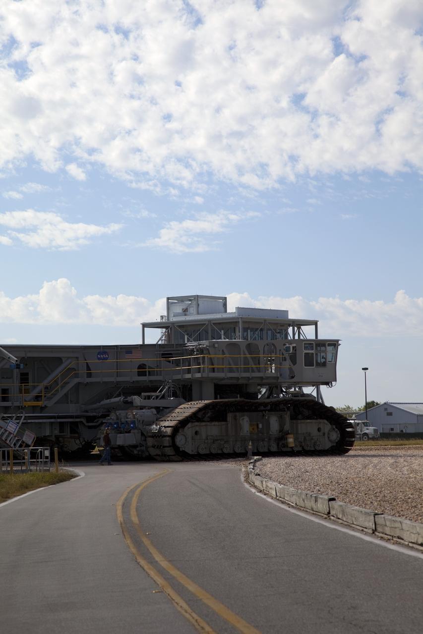 CAPE CANAVERAL, Fla. -- At NASA's Kennedy Space Center in Florida, crawler-transporter No. 2 moves along the gravel crawler way after completion of testing at Launch Pad 39A. The activity is designed to check out recently completed modifications to ensure the crawler-transporter's ability to carry launch vehicles such as the space agency's Space Launch System heavy-lift rocket to the pad. NASA's Ground Systems Development and Operations Program is leading the 20-year life-extension project for the crawler. A pair of behemoth machines called crawler-transporters has carried the load of taking rockets and spacecraft to the launch pad for more than 40 years at NASA’s Kennedy Space Center in Florida. Each weighing six and a half million pounds and larger in size than a professional baseball infield, the crawler-transporters are powered by locomotive and large electrical power generator engines. The crawler-transporters will stand ready to keep up the work for the next generation of launch vehicles to lift astronauts into space. For more information, visit http://www.nasa.gov/exploration/systems/ground/index.html Photo credit: NASA/Frankie Martin