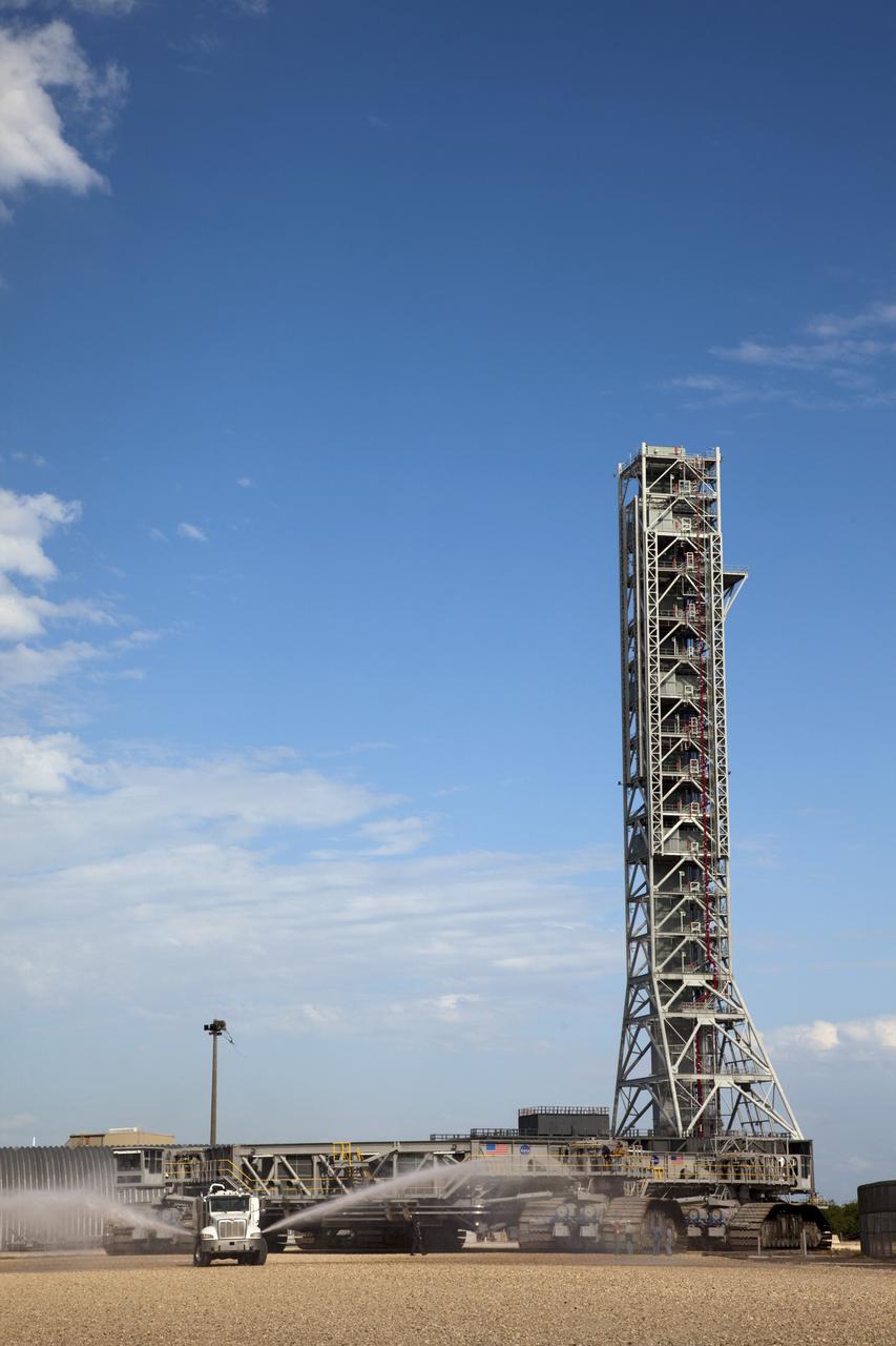 CAPE CANAVERAL, Fla. -- At NASA's Kennedy Space Center in Florida, crawler-transporter No. 2 returns to its park site after completion of testing at Launch Pad 39A. The activity is designed to check out recently completed modifications to ensure the crawler-transporter's ability to carry launch vehicles such as the space agency's Space Launch System heavy-lift rocket to the pad. NASA's Ground Systems Development and Operations Program is leading the 20-year life-extension project for the crawler. A pair of behemoth machines called crawler-transporters has carried the load of taking rockets and spacecraft to the launch pad for more than 40 years at NASA’s Kennedy Space Center in Florida. Each weighing six and a half million pounds and larger in size than a professional baseball infield, the crawler-transporters are powered by locomotive and large electrical power generator engines. The crawler-transporters will stand ready to keep up the work for the next generation of launch vehicles to lift astronauts into space. For more information, visit http://www.nasa.gov/exploration/systems/ground/index.html Photo credit: NASA/Frankie Martin