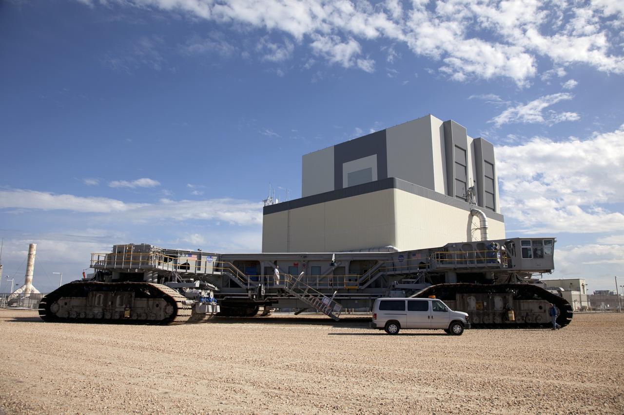 CAPE CANAVERAL, Fla. -- At NASA's Kennedy Space Center in Florida, crawler-transporter No. 2 returns to its park site after completion of testing at Launch Pad 39A. The activity is designed to check out recently completed modifications to ensure the crawler-transporter's ability to carry launch vehicles such as the space agency's Space Launch System heavy-lift rocket to the pad. NASA's Ground Systems Development and Operations Program is leading the 20-year life-extension project for the crawler. A pair of behemoth machines called crawler-transporters has carried the load of taking rockets and spacecraft to the launch pad for more than 40 years at NASA’s Kennedy Space Center in Florida. Each weighing six and a half million pounds and larger in size than a professional baseball infield, the crawler-transporters are powered by locomotive and large electrical power generator engines. The crawler-transporters will stand ready to keep up the work for the next generation of launch vehicles to lift astronauts into space. For more information, visit http://www.nasa.gov/exploration/systems/ground/index.html Photo credit: NASA/Frankie Martin
