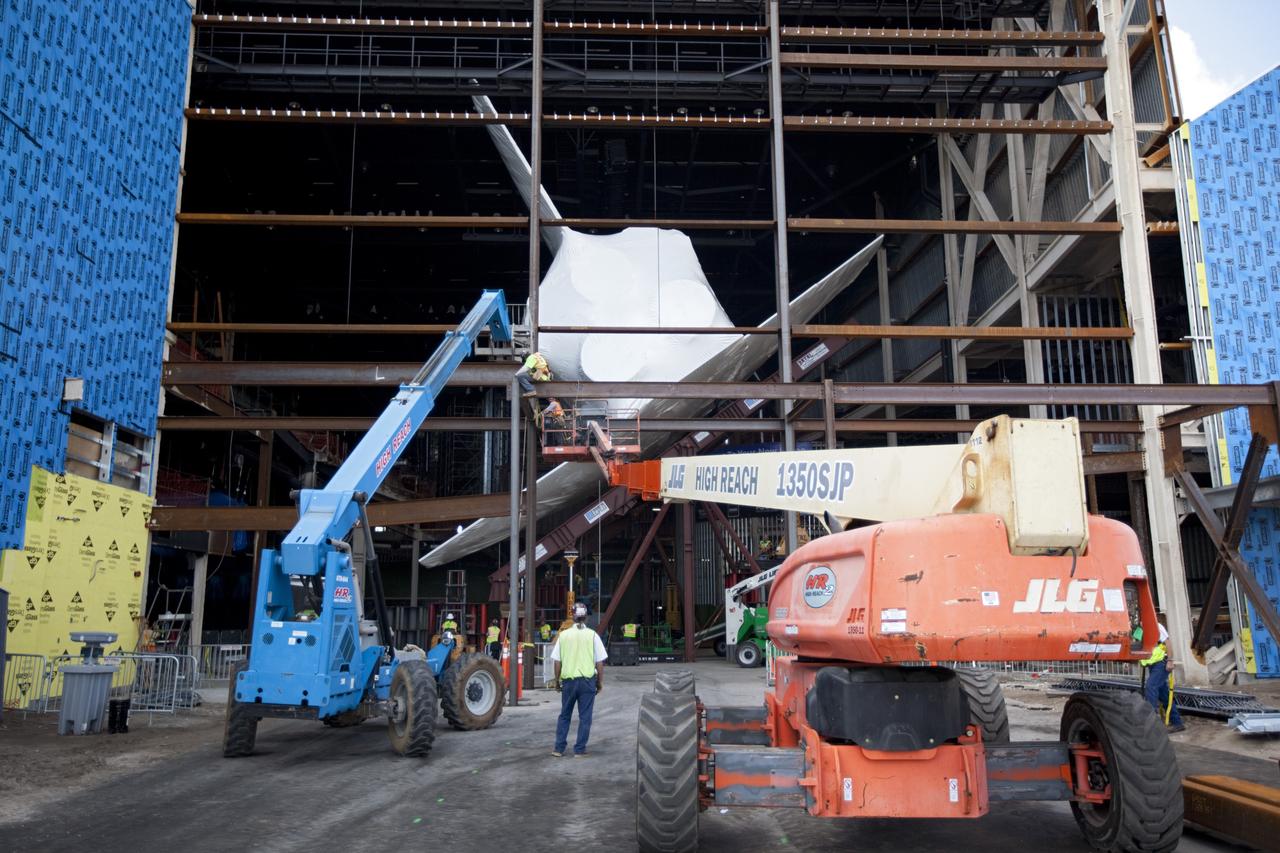 CAPE CANAVERAL, Fla. – The space shuttle Atlantis is lifted and tilted for display at the Kennedy Space Center Visitor Complex in Florida. Atlantis will be exhibited at 43.21 degrees with its payload bay doors open so the shuttle will look as it did in space. Atlantis was wrapped in a protective plastic to protect it from dust and debris while being prepared for display. The new home of Atlantis is scheduled to open in July 2013. The exhibits in the new, 90,000-square-foot interactive facility will tell the story of the 30-year Space Shuttle Program and what lies ahead in space exploration. More than 60 exhibits will be set up around Atlantis, including a full-scale mockup of the Hubble Space Telescope and a full-scale model of a portion of the International Space Station. Over the course of its 26-year career, Atlantis traveled 125,935,769 miles during 307 days in space over 33 missions. For more information, visit http://www.nasa.gov/transition Photo credit: NASA/ Dimitri Gerondidakis