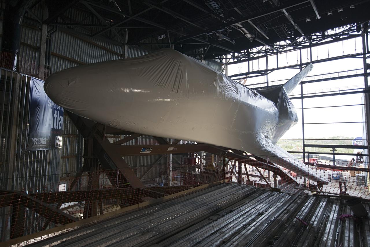 CAPE CANAVERAL, Fla. – The space shuttle Atlantis is lifted and tilted for display at the Kennedy Space Center Visitor Complex in Florida. Atlantis will be exhibited at 43.21 degrees with its payload bay doors open so the shuttle will look as it did in space. Atlantis was wrapped in a protective plastic to protect it from dust and debris while being prepared for display. The new home of Atlantis is scheduled to open in July 2013. The exhibits in the new, 90,000-square-foot interactive facility will tell the story of the 30-year Space Shuttle Program and what lies ahead in space exploration. More than 60 exhibits will be set up around Atlantis, including a full-scale mockup of the Hubble Space Telescope and a full-scale model of a portion of the International Space Station. Over the course of its 26-year career, Atlantis traveled 125,935,769 miles during 307 days in space over 33 missions. For more information, visit http://www.nasa.gov/transition Photo credit: NASA/ Dimitri Gerondidakis