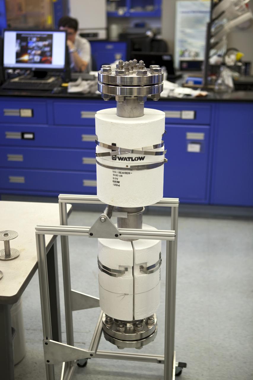 CAPE CANAVERAL, Fla. – The prototype reactor researchers have begun working with to refine what is needed for a space-ready trash-to-gas device. Designers will reduce the weight and size of the machine so it can take up as little room as possible in a spacecraft. A group of six researchers at Kennedy and groups from NASA centers in Ohio, California and Texas wrote in a recent paper that the current methods of handling trash – either carrying it along on the round trip through space or gathering it into an expendable module and burning it up in Earth's atmosphere – are not suitable answers for missions that go beyond Earth orbit or even past the moon. Working in a laboratory at Kennedy, Hintze's team built an 80-pound device that looks like a three-foot-long metal pipe to test theories about incinerating a variety of trash ranging from used clothes to uneaten food. The reactor holds more than three quarts of material and burns at about 1,000 degrees F, about twice the maximum temperature of an average household oven. It's expected to take astronauts four hours to burn a day's worth of trash from a crew of four. During the course of a year in space – one half the length of time a mission to Mars is expected to take – trash processing for a crew of four would create about 2,200 pounds of methane fuel, enough to power a launch from the lunar surface, Hintze said. Photo credit: NASA/Dmitri Gerondidakis