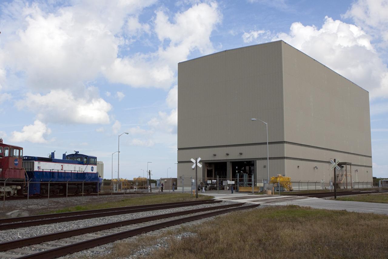 CAPE CANAVERAL, Fla. – Three NASA railroad locomotives at Kennedy Space Center in Florida move toward Launch Complex 39 area's Rotation, Processing and Surge Facility, or RPSF. The operation was to allow wheel and axle assemblies to be swapped between two of the locomotives. The RPSF was built to support work on the solid rocket used motors during the space shuttle era. The facility had never previously been used for another purpose, but is now free to serve other customers. With rails running into the building's high bay and a pair of heavy-lift cranes positioned overhead, the facility's capabilities were a perfect fit for the NASA Railroad's needs. Railroad managers wanted to trade the wheel and axle assemblies, or trucks, of locomotives No. 2 and No. 3. Locomotive No. 3 was painstakingly restored in recent years by the NASA Railroad team, and handles much of the rail work required at the center in the post-shuttle era. But the trucks on locomotive No. 2 are in better shape and are more environmentally friendly. For more information, visit: http://www.nasa.gov/exploration/systems/ground/rpsf_locomotives.html Photo credit: NASA/Jim Grossmann
