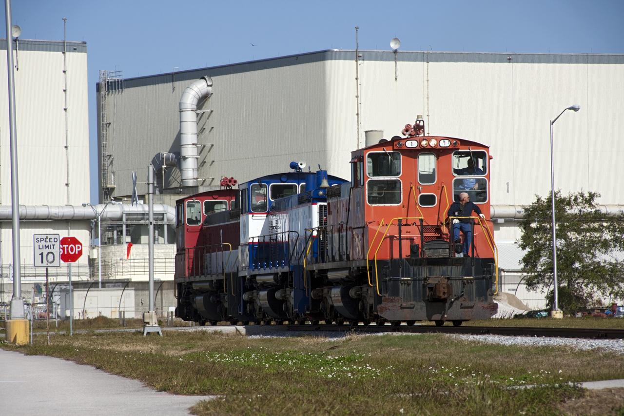 CAPE CANAVERAL, Fla. – At Kennedy Space Center in Florida, NASA railroad locomotive No. 1 returns locomotives 2 and 3 to Launch Complex 39 area's rail yard after wheel and axle assemblies were swapped between locomotives 2 and 3. The RPSF was built to support work on the solid rocket used motors during the space shuttle era. The facility had never previously been used for another purpose, but is now free to serve other customers. With rails running into the building's high bay and a pair of heavy-lift cranes positioned overhead, the facility's capabilities were a perfect fit for the NASA Railroad's needs. Railroad managers wanted to trade the wheel and axle assemblies, or trucks, of locomotives No. 2 and No. 3. Locomotive No. 3 was painstakingly restored in recent years by the NASA Railroad team, and handles much of the rail work required at the center in the post-shuttle era. But the trucks on locomotive No. 2 are in better shape and are more environmentally friendly. For more information, visit: http://www.nasa.gov/exploration/systems/ground/rpsf_locomotives.html Photo credit: NASA/Jim Grossmann
