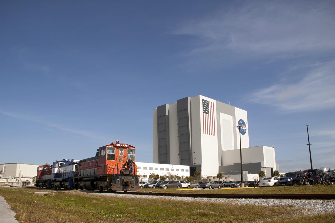 CAPE CANAVERAL, Fla. – At Kennedy Space Center in Florida, NASA railroad locomotive No. 1 returns locomotives 2 and 3 to Launch Complex 39 area's rail yard after wheel and axle assemblies were swapped between locomotives 2 and 3. The RPSF was built to support work on the solid rocket used motors during the space shuttle era. The facility had never previously been used for another purpose, but is now free to serve other customers. With rails running into the building's high bay and a pair of heavy-lift cranes positioned overhead, the facility's capabilities were a perfect fit for the NASA Railroad's needs. Railroad managers wanted to trade the wheel and axle assemblies, or trucks, of locomotives No. 2 and No. 3. Locomotive No. 3 was painstakingly restored in recent years by the NASA Railroad team, and handles much of the rail work required at the center in the post-shuttle era. But the trucks on locomotive No. 2 are in better shape and are more environmentally friendly. For more information, visit: http://www.nasa.gov/exploration/systems/ground/rpsf_locomotives.html Photo credit: NASA/Jim Grossmann