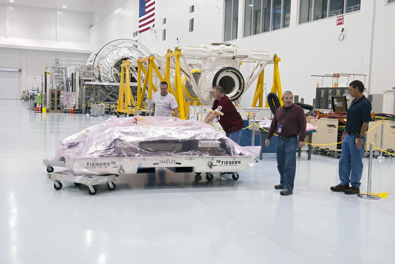 CAPE CANAVERAL, Fla. -- Workers inside the high bay of the Space Station Processing Facility at NASA's Kennedy Space Center in Florida prepare to pack the orbital replacement unit for the space station's utility transfer assembly in a shipping container. The assembly, which was processed at Kennedy, will be shipped to Japan at the beginning of the year for the HTV-4 launch, which is currently scheduled for 2013. Photo credit: NASA/Charisse Nahser