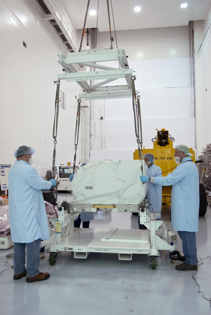 CAPE CANAVERAL, Fla. -- Workers inside the high bay of the Space Station Processing Facility at NASA's Kennedy Space Center in Florida lift the orbital replacement unit for the space station's utility transfer assembly before placing it in a shipping container. The assembly, which was processed at Kennedy, will be shipped to Japan at the beginning of the year for the HTV-4 launch, which is currently scheduled for 2013. Photo credit: NASA/Charisse Nahser