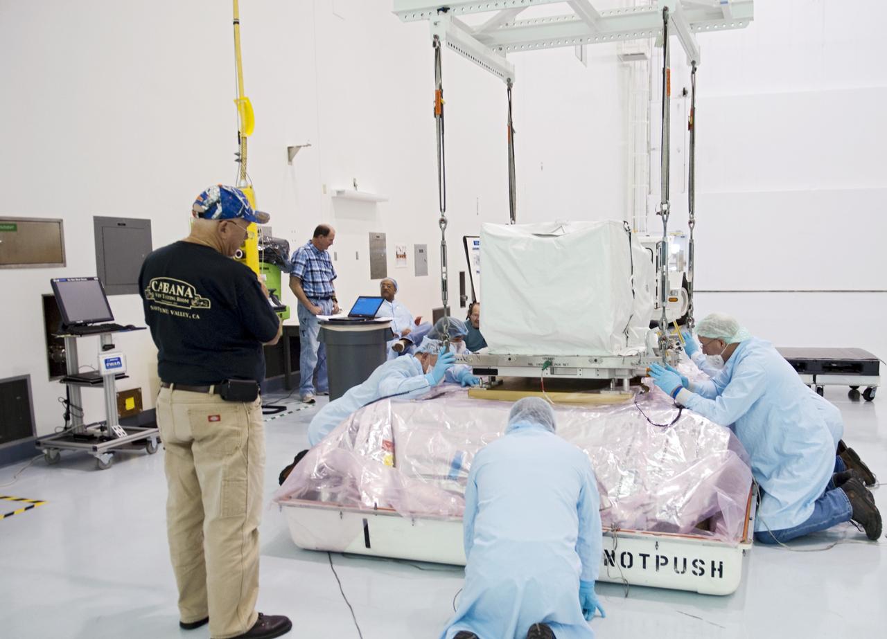 CAPE CANAVERAL, Fla. -- Workers inside the high bay of the Space Station Processing Facility at NASA's Kennedy Space Center in Florida position the orbital replacement unit for the space station's utility transfer assembly on the bottom portion of a shipping container. The assembly, which was processed at Kennedy, will be shipped to Japan at the beginning of the year for the HTV-4 launch, which is currently scheduled for 2013. Photo credit: NASA/Charisse Nahser