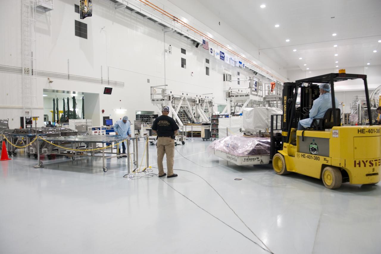 CAPE CANAVERAL, Fla. -- Workers inside the high bay of the Space Station Processing Facility at NASA's Kennedy Space Center in Florida move the orbital replacement unit for the space station's utility transfer assembly that has been placed in the bottom portion of a shipping container. The assembly, which was processed at Kennedy, will be shipped to Japan at the beginning of the year for the HTV-4 launch, which is currently scheduled for 2013. Photo credit: NASA/Charisse Nahser