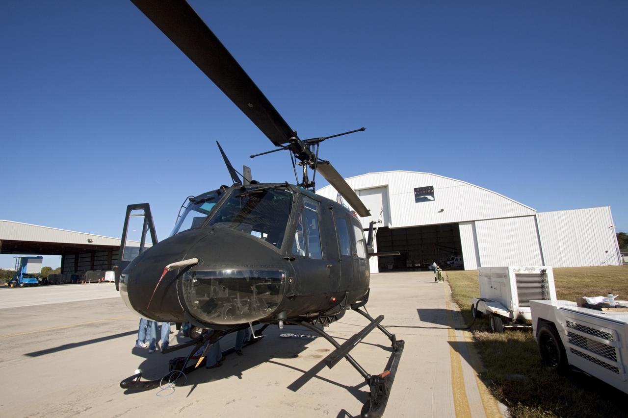 CAPE CANAVERAL, Fla. – Near the Shuttle Landing Facility at NASA's Kennedy Space Center in Florida, a space agency team installed and tested hazard avoidance instrumentation on a Huey helicopter. Led by the Johnson Space Center and supported by Jet Propulsion Laboratory and Langley Research Center, the Autonomous Landing Hazard Avoidance Technology, or ALHAT, laser system provides a planetary lander the ability to precisely land safely on a surface while detecting any dangerous obstacles such as rocks, holes and slopes. Just north of Kennedy's Shuttle Landing Facility runway, a rock- and crater-filled planetary scape has been built so engineers can test the ability to negotiate away from risks. Photo credit: NASA/Jim Grossmann