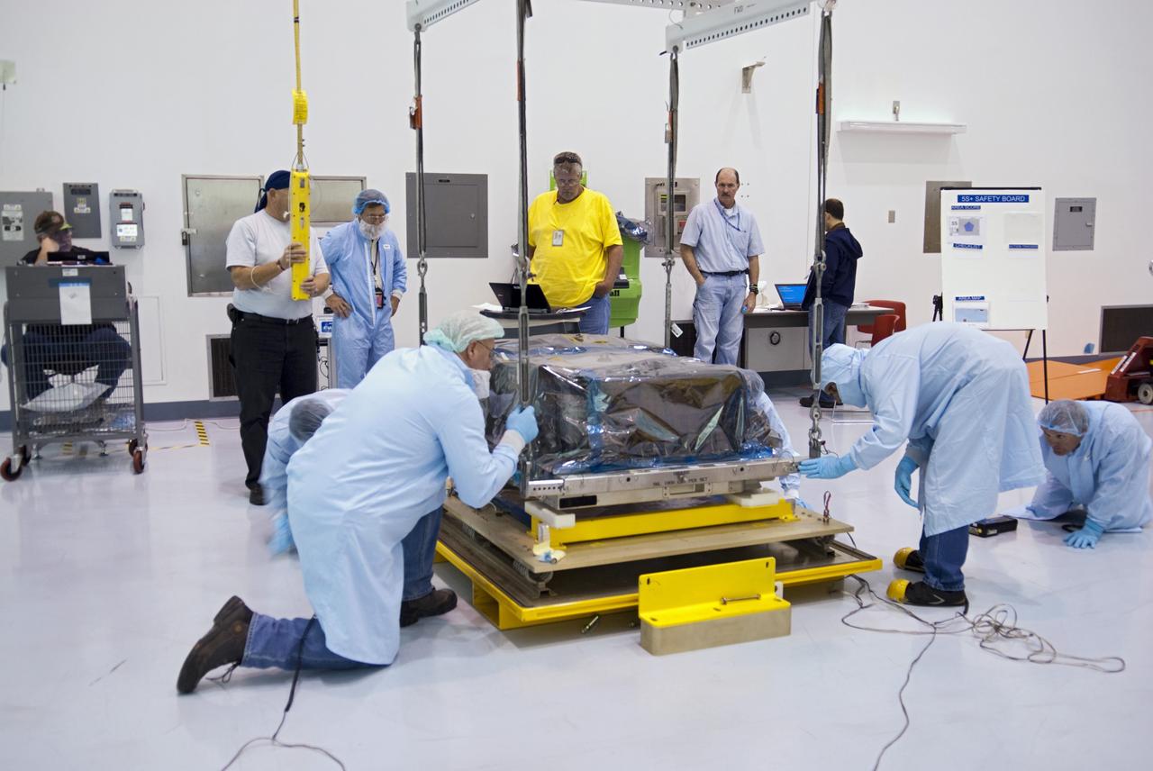 CAPE CANAVERAL, Fla. -- Workers inside the Space Station Processing Facility at NASA's Kennedy Space Center in Florida position the orbital replacement unit for the space station's main bus switching unit as they prepare to pack the unit in a shipping container.        The unit, which was processed at Kennedy, will be shipped to Japan at the beginning of the year for the HTV-4 launch, which is currently scheduled for 2013. Photo credit: NASA/Charisse Nahser