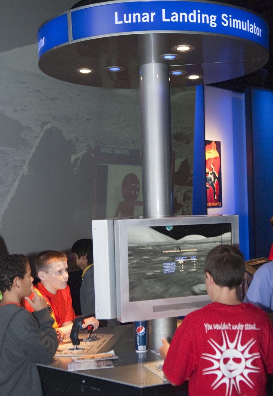 CAPE CANAVERAL, Fla. – At the Kennedy Space Center Visitor Complex in Florida sixth-grade students use a computer simulation to practice landing a spacecraft on the moon.      Between Nov. 26 and Dec. 7, 2012, about 5,300 sixth-graders in Brevard County, Florida were bused to Kennedy's Visitor Complex for Brevard Space Week, an educational program designed to encourage interest in science, technology, engineering and mathematics STEM careers. Photo credit: NASA/Tim Jacobs