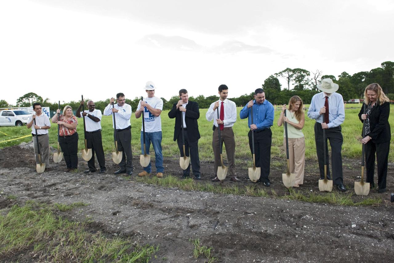 CAPE CANAVERAL, Fla. -- At NASA’s Kennedy Space Center in Florida, a groundbreaking was held to mark the start of construction on the Antenna Test Bed Array for the Ka-Band Objects Observation and Monitoring, or Ka-BOOM system. Holding ceremonial shovels, from left are Michael Le, lead design engineer and construction manager Sue Vingris, Cape Design Engineer Co. project manager Kannan Rengarajan, chief executive officer of Cape Design Engineer Co. Lutfi Mized, president of Cape Design Engineer Co. David Roelandt, construction site superintendent with Cape Design Engineer Co. Marc Seibert, NASA project manager Michael Miller, NASA project manager Peter Aragona, KSC’s Electromagnetic Lab manager Stacy Hopper, KSCs master planning supervisor Dr. Bary Geldzabler, NASA chief scientist and KSC’s Chief Technologist Karen Thompson. The construction site is near the former Vertical Processing Facility, which has been demolished. Workers will begin construction on the pile foundations for the 40-foot-diameter dish antenna arrays and their associated utilities, and prepare the site for the operations command center facility. Photo credit: NASA/Charisse Nahser
