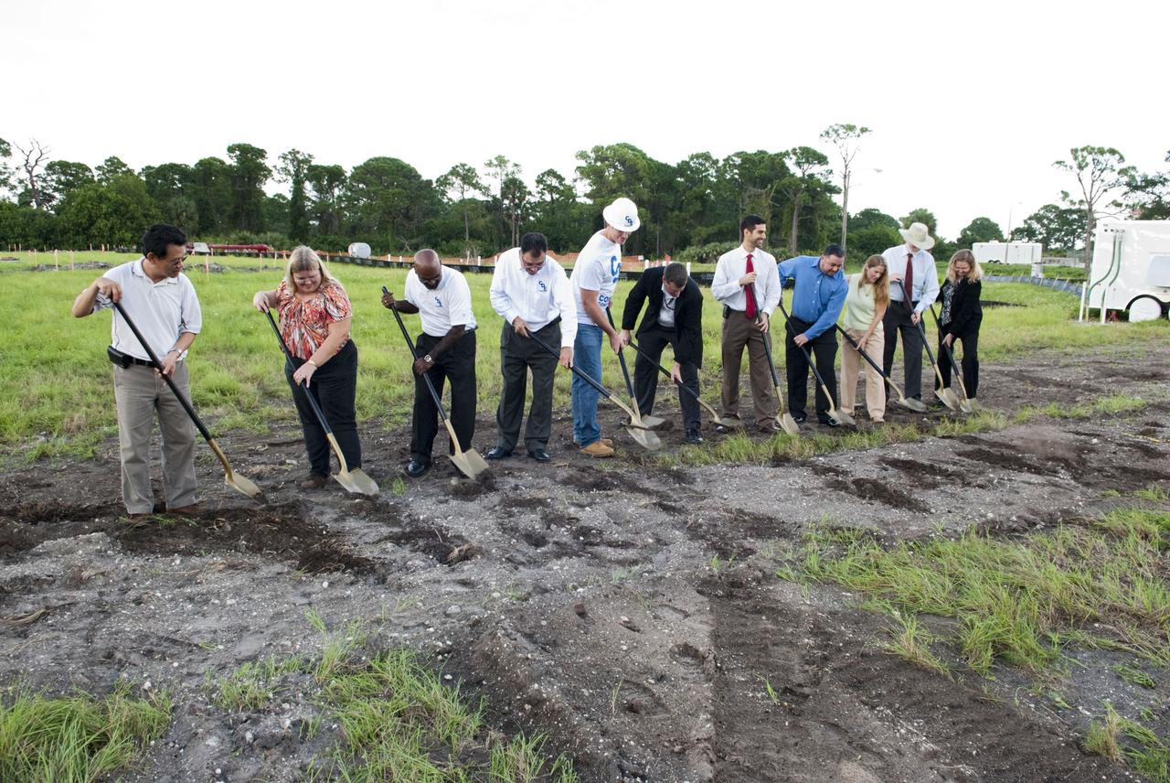 CAPE CANAVERAL, Fla. -- At NASA’s Kennedy Space Center in Florida, a groundbreaking was held to mark the start of construction on the Antenna Test Bed Array for the Ka-Band Objects Observation and Monitoring, or Ka-BOOM system. Using ceremonial shovels to mark the site, from left are Michael Le, lead design engineer and construction manager Sue Vingris, Cape Design Engineer Co. project manager Kannan Rengarajan, chief executive officer of Cape Design Engineer Co. Lutfi Mized, president of Cape Design Engineer Co. David Roelandt, construction site superintendent with Cape Design Engineer Co. Marc Seibert, NASA project manager Michael Miller, NASA project manager Peter Aragona, KSC’s Electromagnetic Lab manager Stacy Hopper, KSCs master planning supervisor Dr. Bary Geldzabler, NASA chief scientist and KSC’s Chief Technologist Karen Thompson. The construction site is near the former Vertical Processing Facility, which has been demolished. Workers will begin construction on the pile foundations for the 40-foot-diameter dish antenna arrays and their associated utilities, and prepare the site for the operations command center facility. Photo credit: NASA/Charisse Nahser