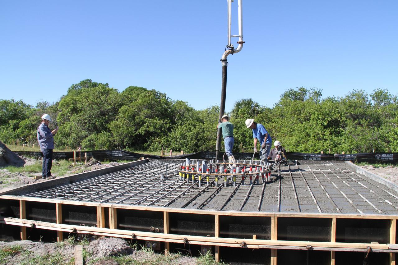 CAPE CANAVERAL, Fla. – At NASA’s Kennedy Space Center in Florida, workers continue construction of the Antenna Test Bed Array for the Ka-Band Objects Observation and Monitoring, or Ka-BOOM, system.    The construction site is near the former Vertical Processing Facility, which has been demolished. Workers are placing the pile foundations for the 40-foot-diameter dish antenna arrays and their associated utilities, and preparing the site for the operations command center facility. Photo credit: NASA/Ben Smegelski